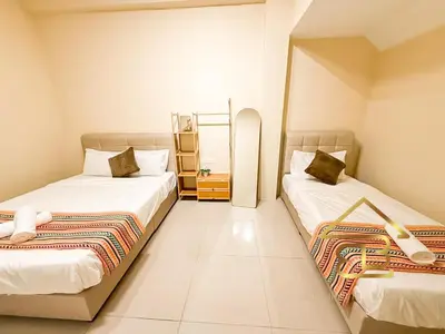 two beds in a small room with white walls at Ipoh Indoor Pool Homestay, BBQ Mahjong, 16 pax 4BR in Ipoh
