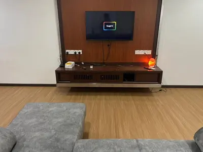 a living room with a tv and a couch at LIY Homestay in Gua Sai