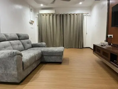 a living room with a couch and a television at LIY Homestay in Gua Sai