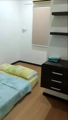 a bedroom with a bed and a dresser in a room at LIY Homestay in Gua Sai