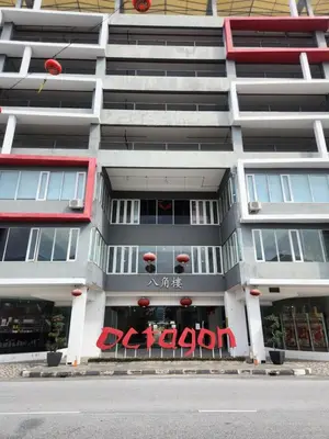 a large apartment building with a red sign on it at The Octagon Ipoh - City Centre Premium Stay in Ipoh