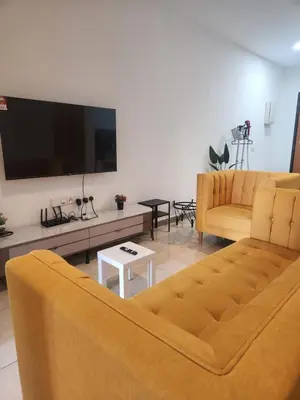 a living room with a couch and a flat screen tv at The Octagon Ipoh - City Centre Premium Stay in Ipoh