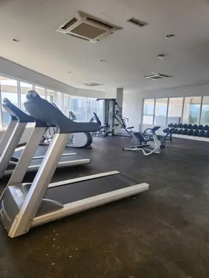 a gym with treadmills and elliptical machines at The Octagon Ipoh - City Centre Premium Stay in Ipoh