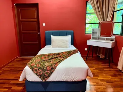 a red room with a bed and a tv at Sunway Lakeside Villa Ipoh in Tambun
