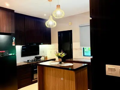 a kitchen with a center island with flowers on it at Sunway Lakeside Villa Ipoh in Tambun