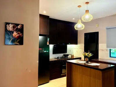 a kitchen with a black refrigerator and a counter top at Sunway Lakeside Villa Ipoh in Tambun