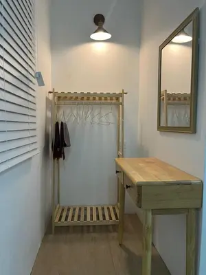 a bathroom with a wooden table and a mirror at Desa Ibol Cottage and River - Max 10Pax