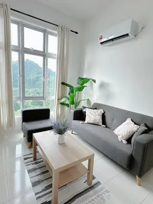 a living room with a couch and a coffee table at The Anderson Cozy Deluxe Homestay in Ipoh