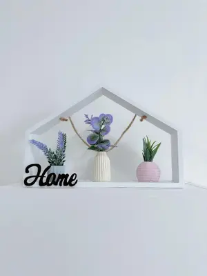 a shelf with flowers and a home sign on it at The Anderson Cozy Deluxe Homestay in Ipoh