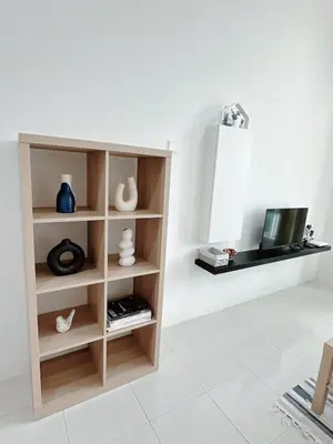 a book shelf in a living room with a tv at The Anderson Cozy Deluxe Homestay in Ipoh