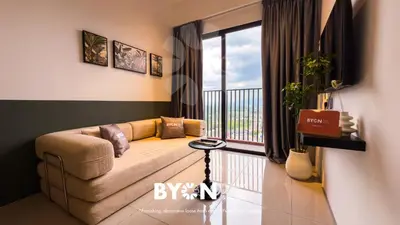 a living room with a couch and a balcony at Piccadilly Premium Suites Ipoh by BYON in Ipoh