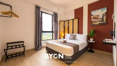 a bedroom with a large bed and a window at Piccadilly Premium Suites Ipoh by BYON in Ipoh