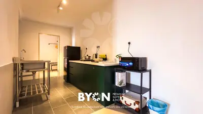 a kitchen with a sink and a counter with a microwave at Piccadilly Premium Suites Ipoh by BYON in Ipoh
