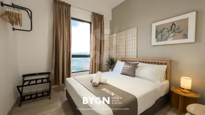 a bedroom with a bed and a large window at Piccadilly Premium Suites Ipoh by BYON in Ipoh