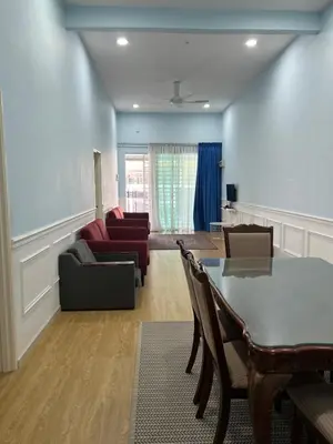 a living room with a table and a couch at Homestay Anisa Batu Gajah 4 Bilik in Batu Gajah