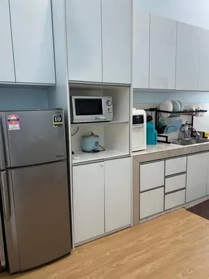 a kitchen with white cabinets and a refrigerator at Homestay Anisa Batu Gajah 4 Bilik in Batu Gajah