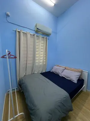 a blue room with a bed and a window at Homestay Anisa Batu Gajah 4 Bilik in Batu Gajah