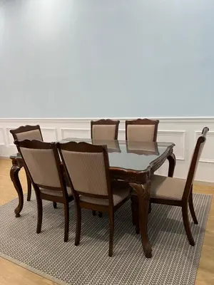 a dining room table with four chairs and a table at Homestay Anisa Batu Gajah 4 Bilik in Batu Gajah