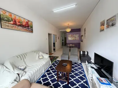 a living room with a couch and a tv at AYAAN RAFFLESIA Home at Cameron Highland in Tanah Rata