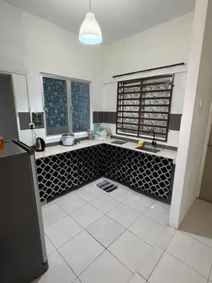 a kitchen with a sink and a refrigerator in it at AYAAN RAFFLESIA Home at Cameron Highland in Tanah Rata
