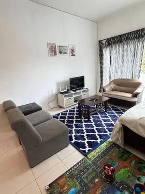 a living room with a couch and a table at AYAAN RAFFLESIA Home at Cameron Highland in Tanah Rata
