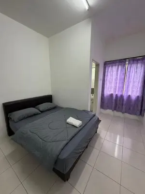 a bedroom with a bed in a room with purple curtains at AYAAN RAFFLESIA Home at Cameron Highland in Tanah Rata