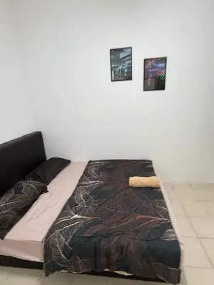 a bed in a room with three pictures on the wall at AYAAN GAMING ARENA at Tanah Rata Cameron Highland in Tanah Rata
