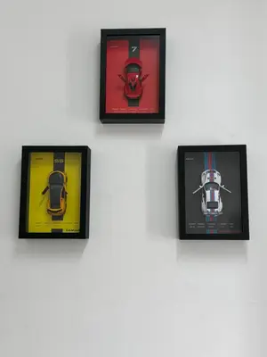 a wall with four pictures of cars on it at AYAAN GAMING ARENA at Tanah Rata Cameron Highland in Tanah Rata