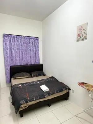 a bedroom with a bed with a purple curtain at AYAAN GAMING ARENA at Tanah Rata Cameron Highland in Tanah Rata