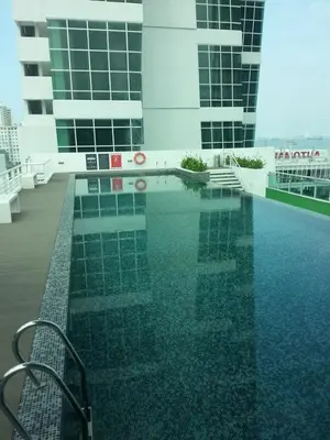 a swimming pool on the roof of a building at Premier Suite at Maritime in George Town
