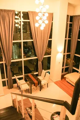 a living room with a chandelier and a large window at Premier Suite at Maritime in George Town