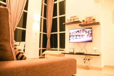 a living room with a tv and a window at Premier Suite at Maritime in George Town