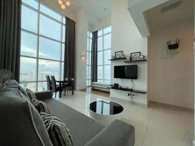 a living room with a couch and a tv at Premier Suite at Maritime in George Town