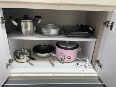 a kitchen shelf with pots and pans and a mixer at Peace HomestayThe Venus Sitiawan in Sitiawan