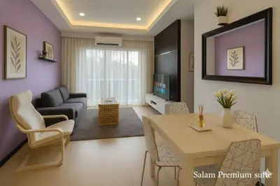 a living room with a table and a living room with a couch at Salam Comfy Suite at Bandar Meru Raya Ipoh in Ipoh