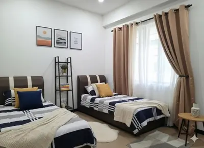 a bedroom with two beds and a window at Salam Comfy Suite at Bandar Meru Raya Ipoh in Ipoh