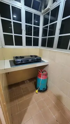a room with a table with a bucket and windows at 9 Storey Apartment Next to Brinchang Centrum Night Market in Cameron Highlands