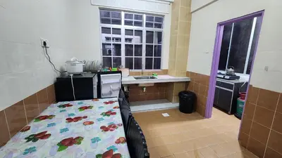 a kitchen with a bed in the middle of a room at 9 Storey Apartment Next to Brinchang Centrum Night Market in Cameron Highlands