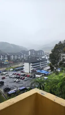 a view of a parking lot with cars in a parking lot at 9 Storey Apartment Next to Brinchang Centrum Night Market in Cameron Highlands