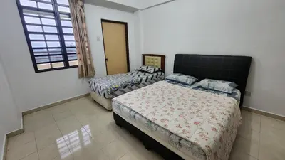 a bedroom with two beds and a window at 9 Storey Apartment Next to Brinchang Centrum Night Market in Cameron Highlands
