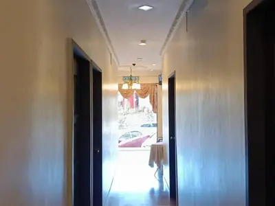 a hallway with a door to a room with a car at Hotel Remix 2 Cameron Highlands in Gua Sai