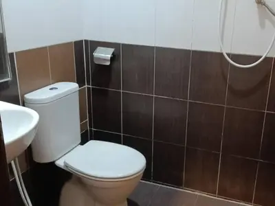 a bathroom with a toilet and a sink at Hotel Remix 2 Cameron Highlands in Gua Sai