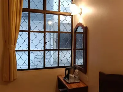 a window in a room with a table and a mirror at Hotel Remix 2 Cameron Highlands in Gua Sai