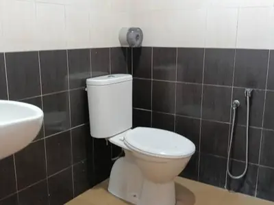 a bathroom with a toilet and a sink at Hotel Remix 2 Cameron Highlands in Gua Sai