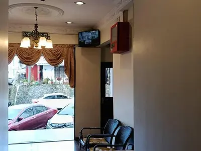 a waiting room with chairs and a window with cars at Hotel Remix 2 Cameron Highlands in Gua Sai
