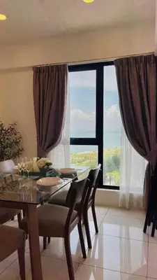 a dining room with a table and a large window at Sunrise Gurney Georgetwon in George Town