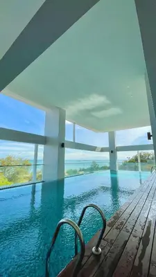 a swimming pool in a house with a view of the water at Sunrise Gurney Georgetwon in George Town