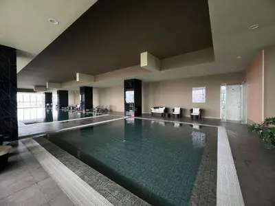a large swimming pool in a building with a lobby at Icc ipoh y2 homestay in Ipoh