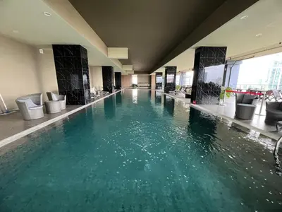a swimming pool in a hotel with green water at Icc ipoh y2 homestay in Ipoh