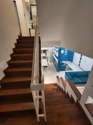 a staircase in a room with a bed and a stair case at Gurney Vacation Gathering Comfy Home - Solok Burma in George Town